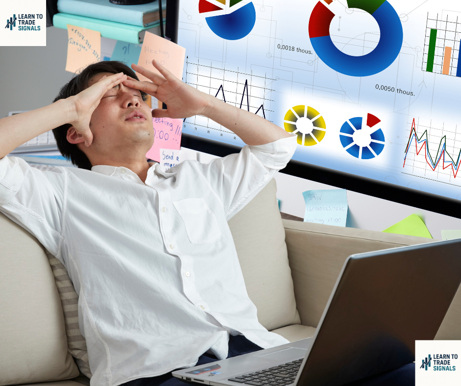 learntotradesignals.com man looking frustrated at desk with trading charts in background